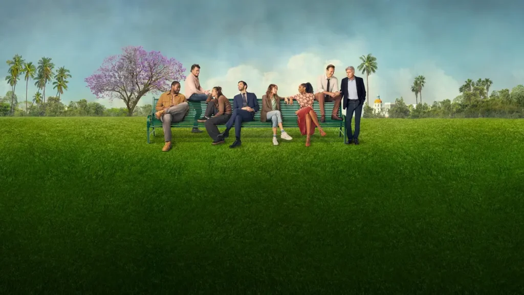 Cast of the comedy TV series Shrinking sitting together on a park bench in a sunny outdoor setting.