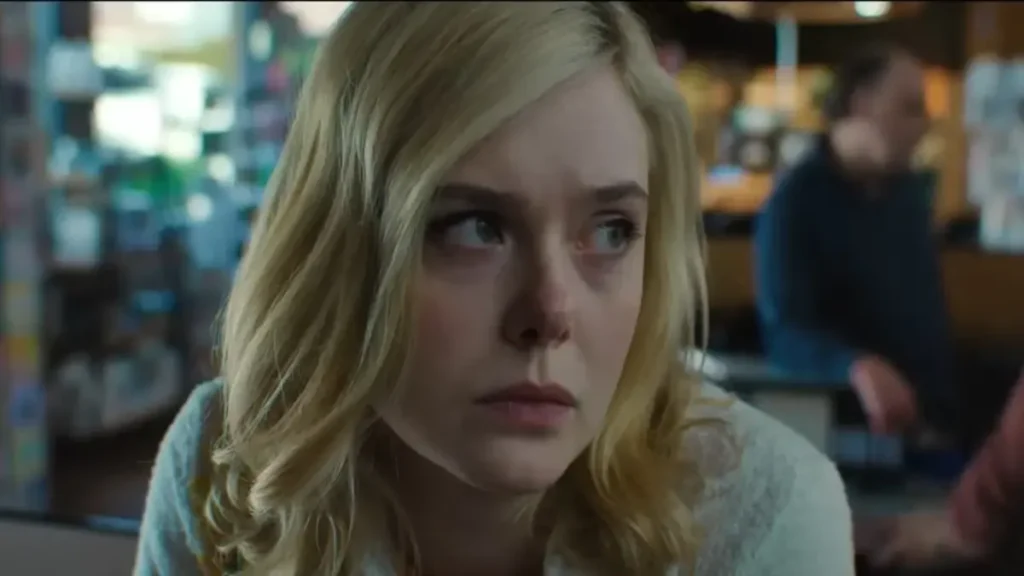 Margo sits alone in a café, reflecting financial stress in Apple TV+ drama Margo’s Got Money Troubles