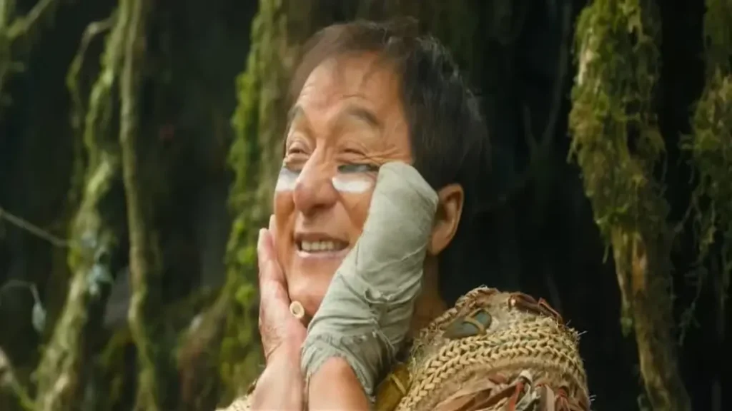 Action film character smiling with bandaged hands in forest setting from Panda Plan 2 trailer