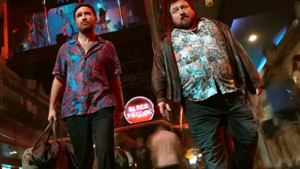 Crooks Season 2 Netflix trailer scene showing two characters walking through neon-lit club street