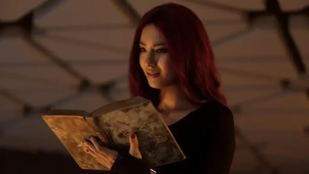 Do Not Enter (2026) Trailer: Plot, Cast & Hidden Horror Clues Woman reading an ancient book in a dark horror scene from Do Not Enter (2026)