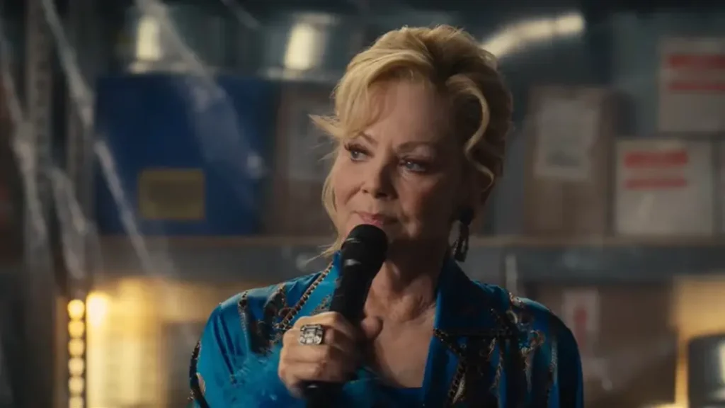 Hacks Season 5 trailer scene showing Deborah Vance holding a microphone on stage