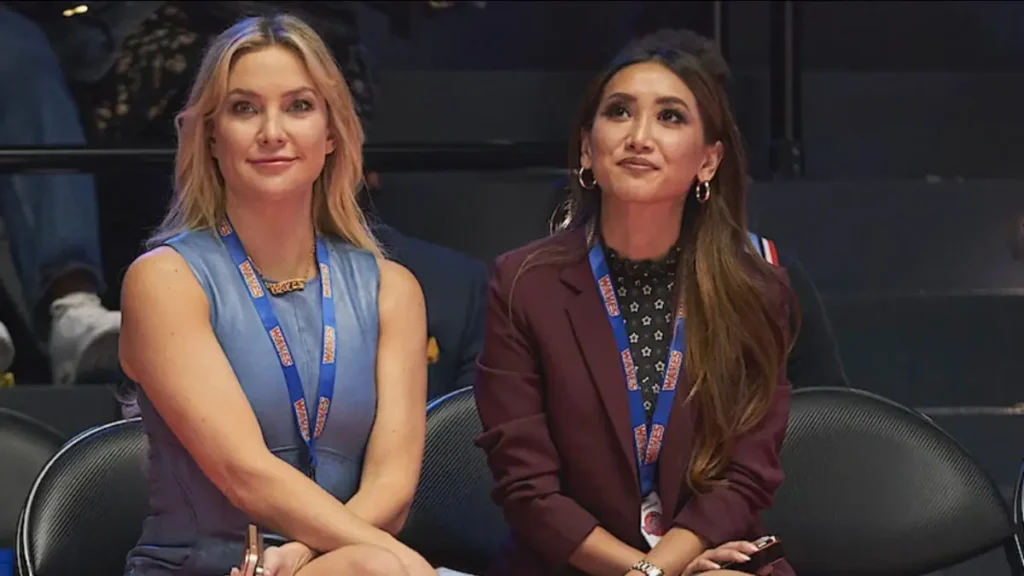 Running Point Season 2: What the Netflix Trailer Reveals Two women in professional attire watching a basketball game in Running Point Season 2 Netflix scene