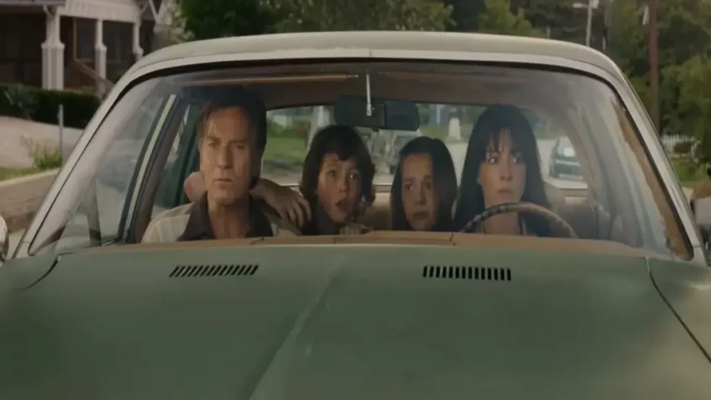 Family sitting in a car with tense expressions in The End of Oak Street teaser trailer