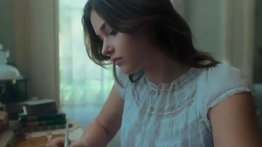 The House of the Spirits trailer scene showing a young woman writing in a softly lit room
