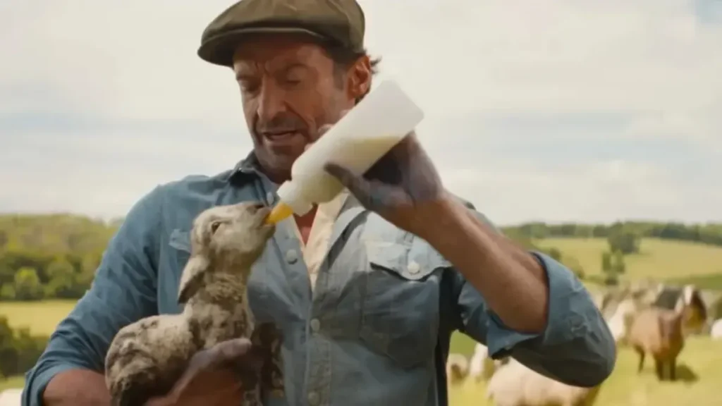 Farmer feeding baby sheep in The Sheep Detectives Trailer 2 scene