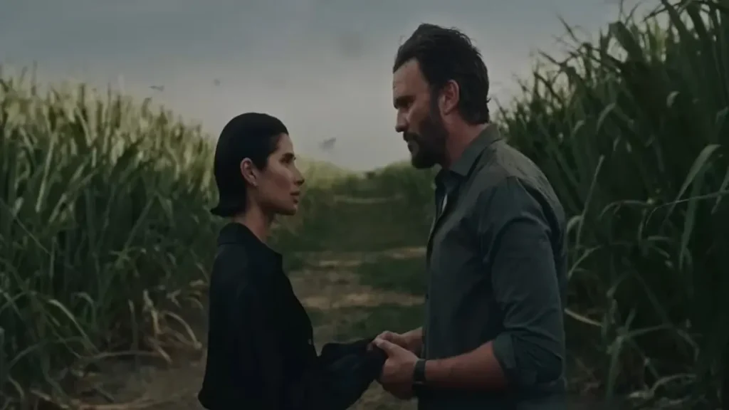 Two characters standing face to face in a tense emotional moment in The Whistler trailer