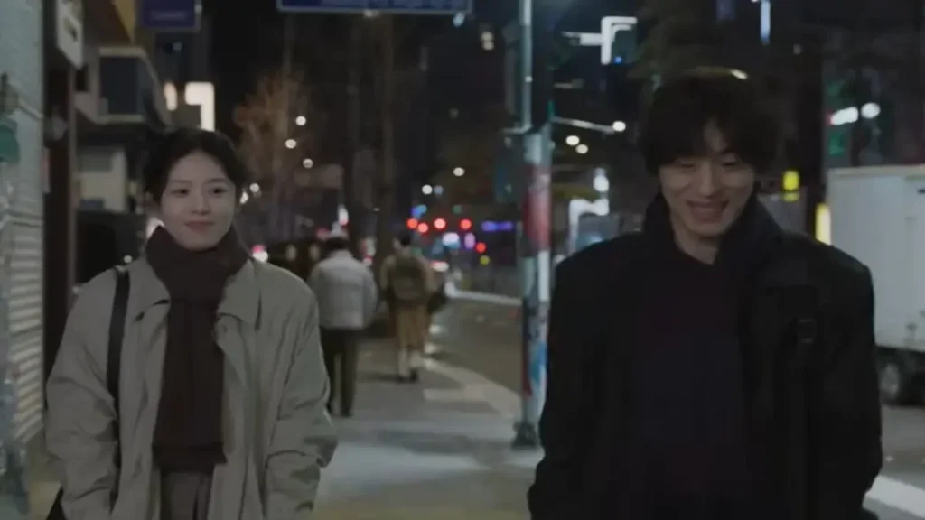 Two individuals walking together at night in a quiet urban street scene from Netflix’s We Are All Trying Here trailer