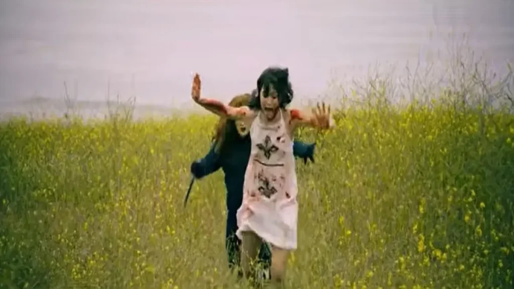 woman running through field in horror scene from Frankie Maniac Woman 2026 trailer