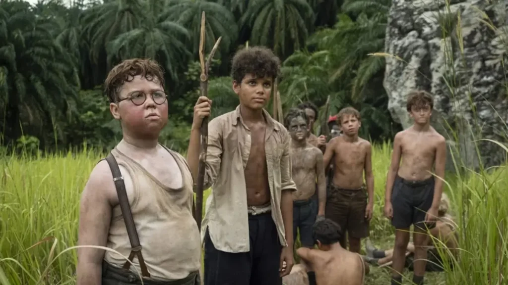 Lord of the Flies 2026 series boys standing in jungle holding spears survival scene