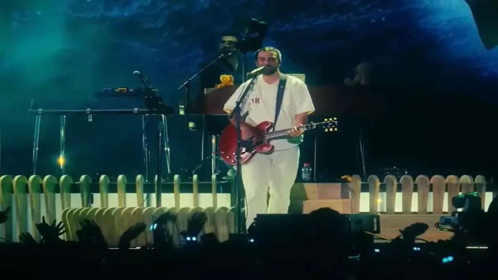 Noah Kahan performing live on stage with guitar during Out of Body Netflix trailer scene