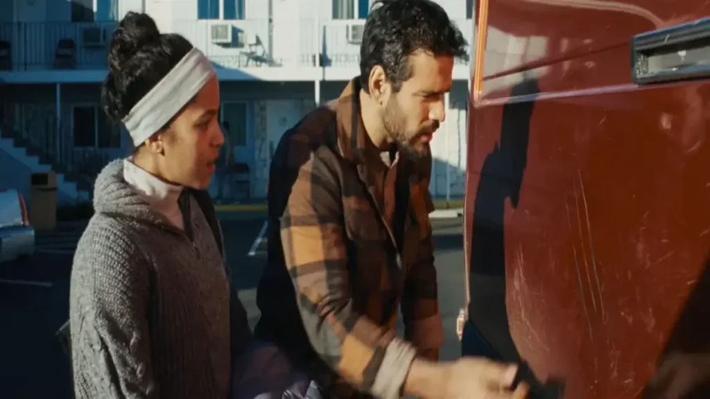 Passenger 2026 movie scene with two characters inspecting a vehicle in a tense moment