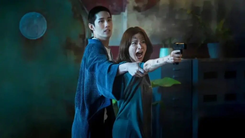 Woman holding a gun beside a man in Netflix Korean thriller My Dearest Assassin