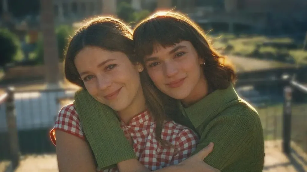 Two young women hugging warmly in golden sunlight from The Map of Longing Netflix teaser