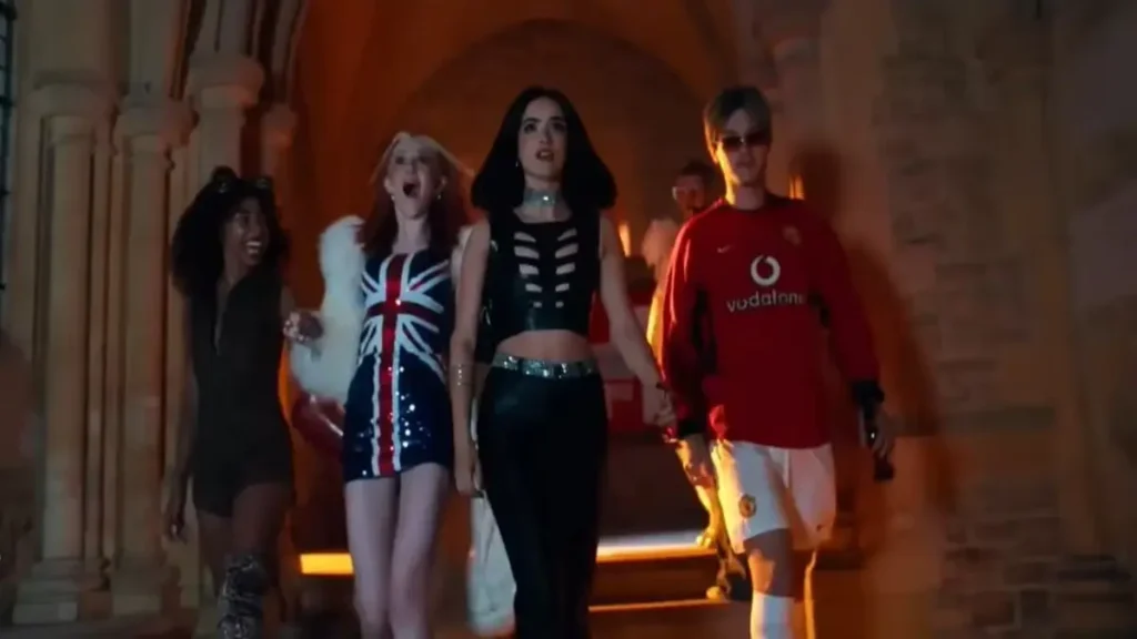 Cast members walking through a gothic hallway in Your Fault: London official trailer scene.
