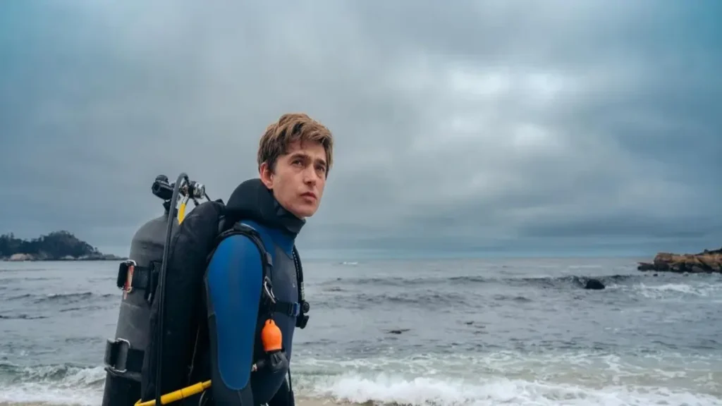 Whalefall movie teaser showing a diver standing on a stormy shoreline before an ocean survival journey.